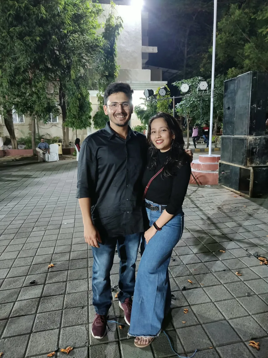 Dr. Apoorva and Dr. Saurabh in black, outdoors at night
